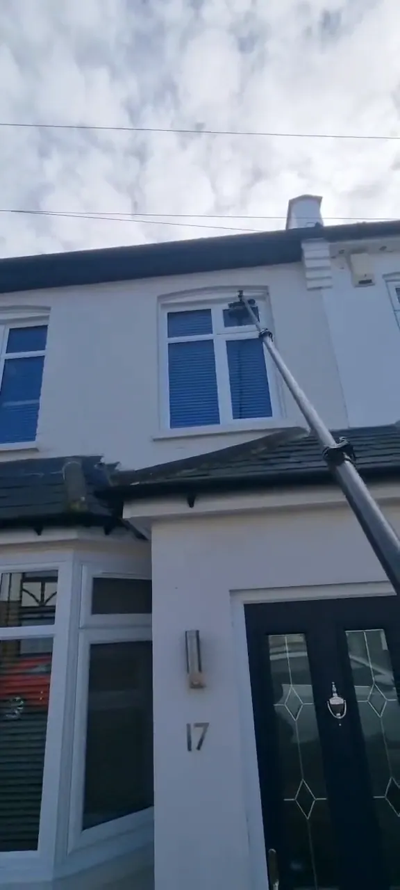 Window cleaner using a water-fed pole in Finchley